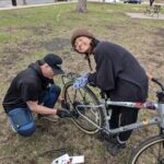 Zinnia getting her bike worked on.